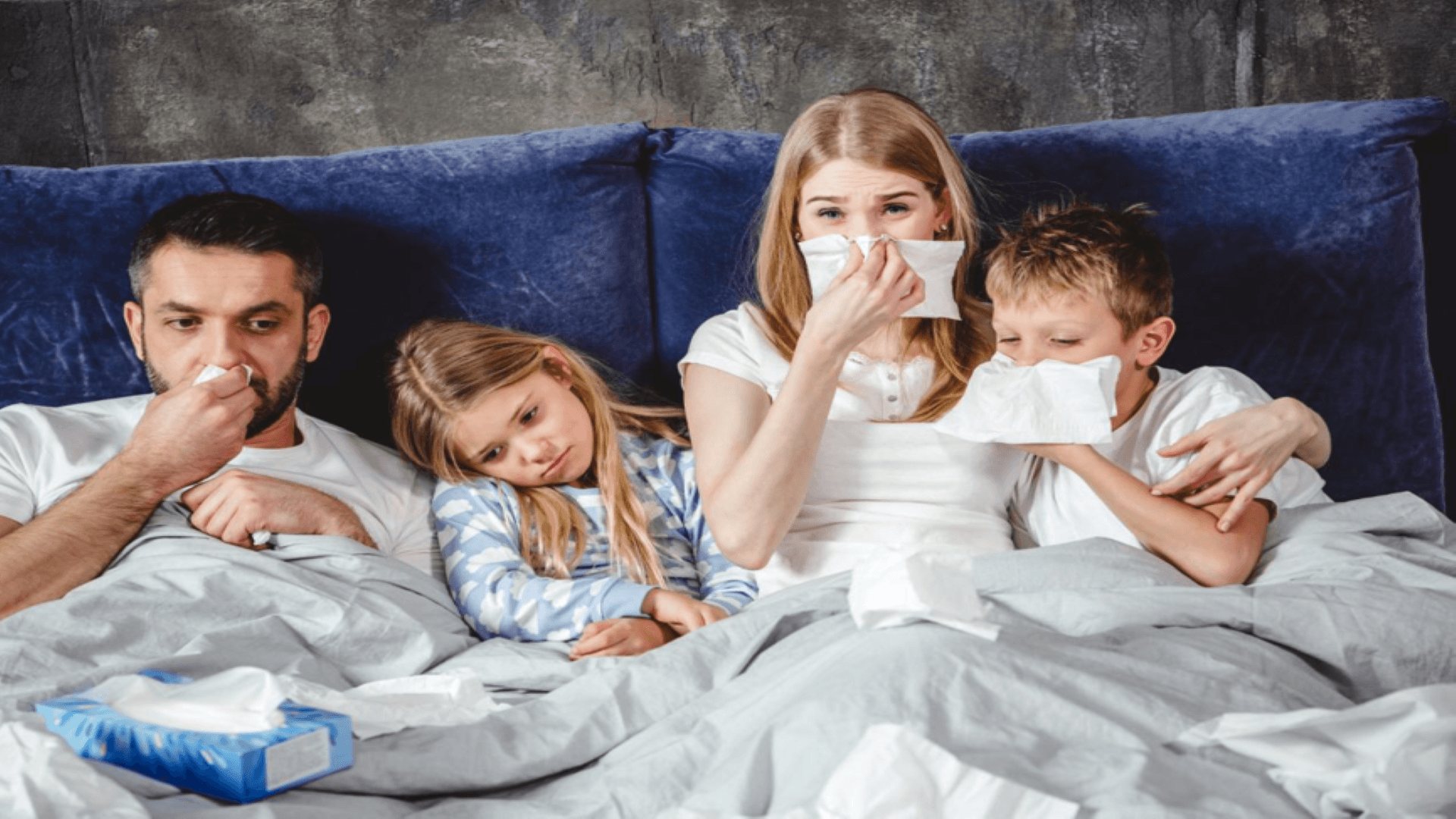 family-in-bed-with-flu-symptoms