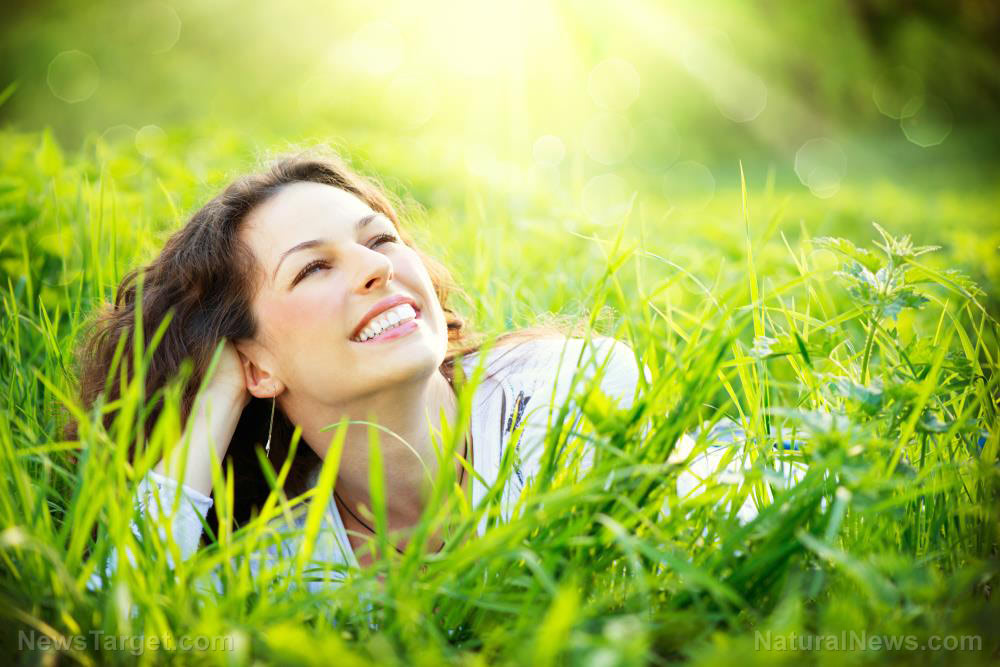 Woman-Smile-Healthy-Lying-Grass-Down-Outside